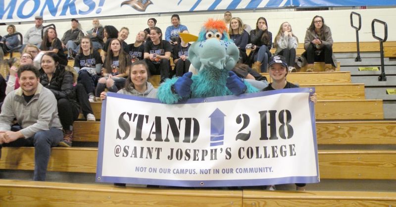 Noh8 2 The College's character "Blue" holds a sign for NOH8 at a basketball game.