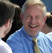 President Jim Dlugos engaged in conversation with a student at Convocation