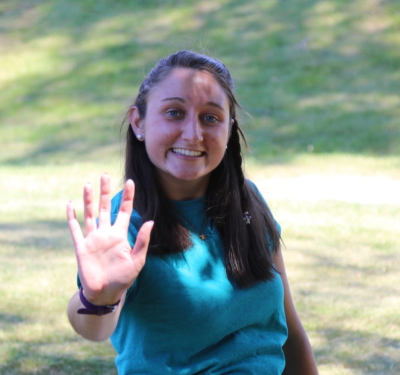 MaryClaire holds her hand out in a high-five, which is the logo for ɫƵ Peer Mentors