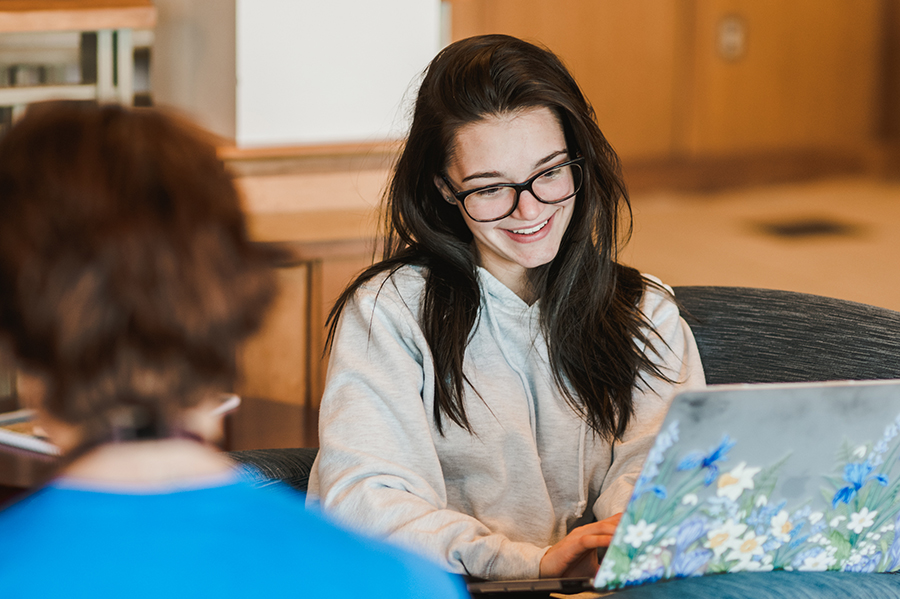 female student studies on a laptop